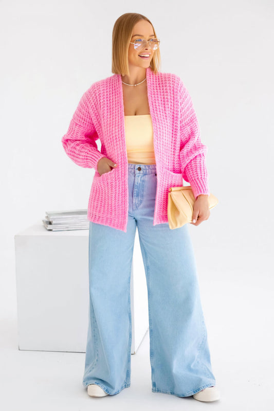 Vorderansicht einer pinken Oversize-Strickjacke aus weichem Wollmix mit Taschen
